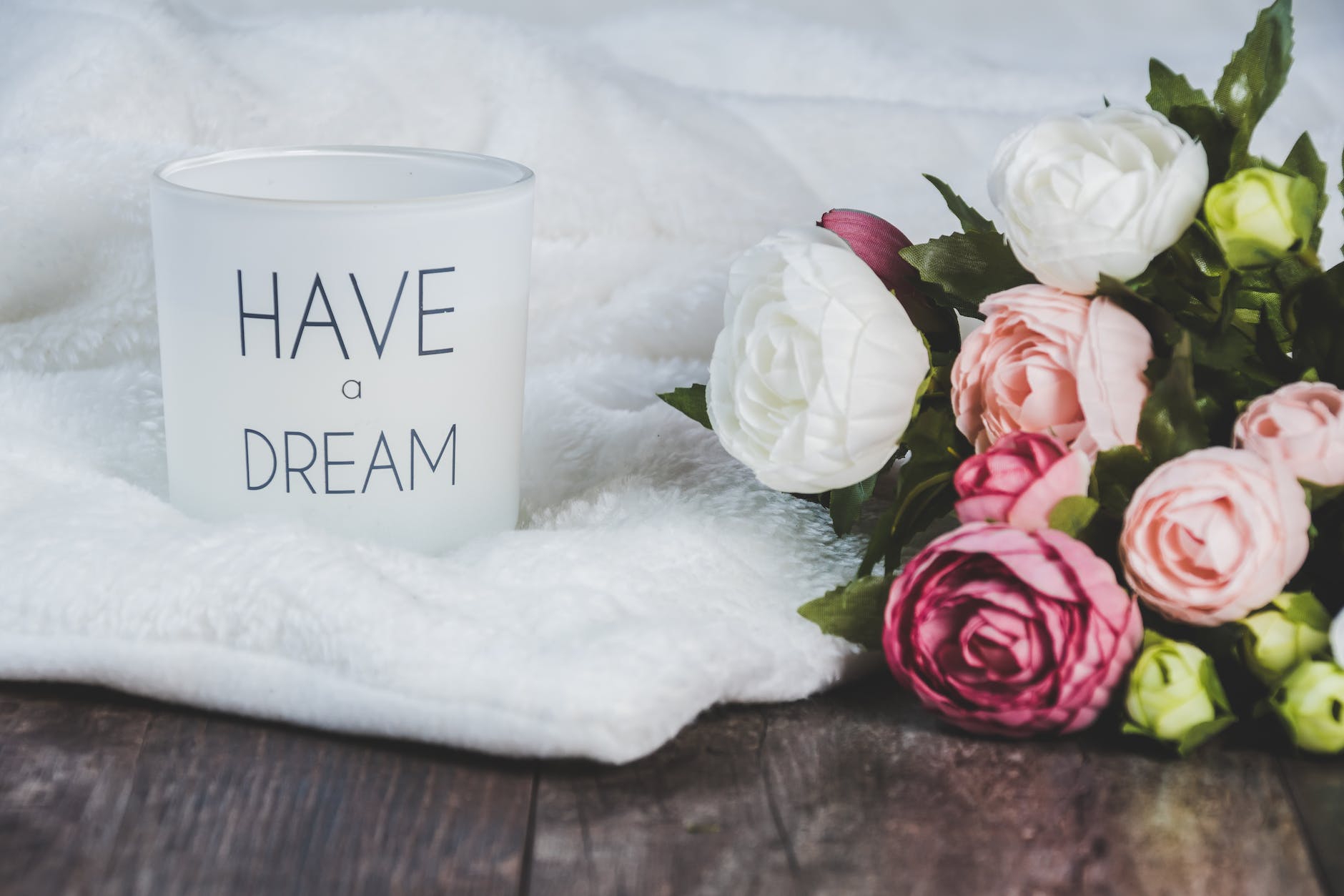 white and pink flowers beside a canister. Jamaican blog.