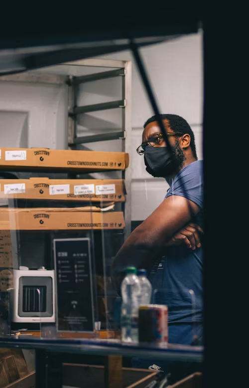 Jobs.
Man in glasses and mask with folded arm, wondering.